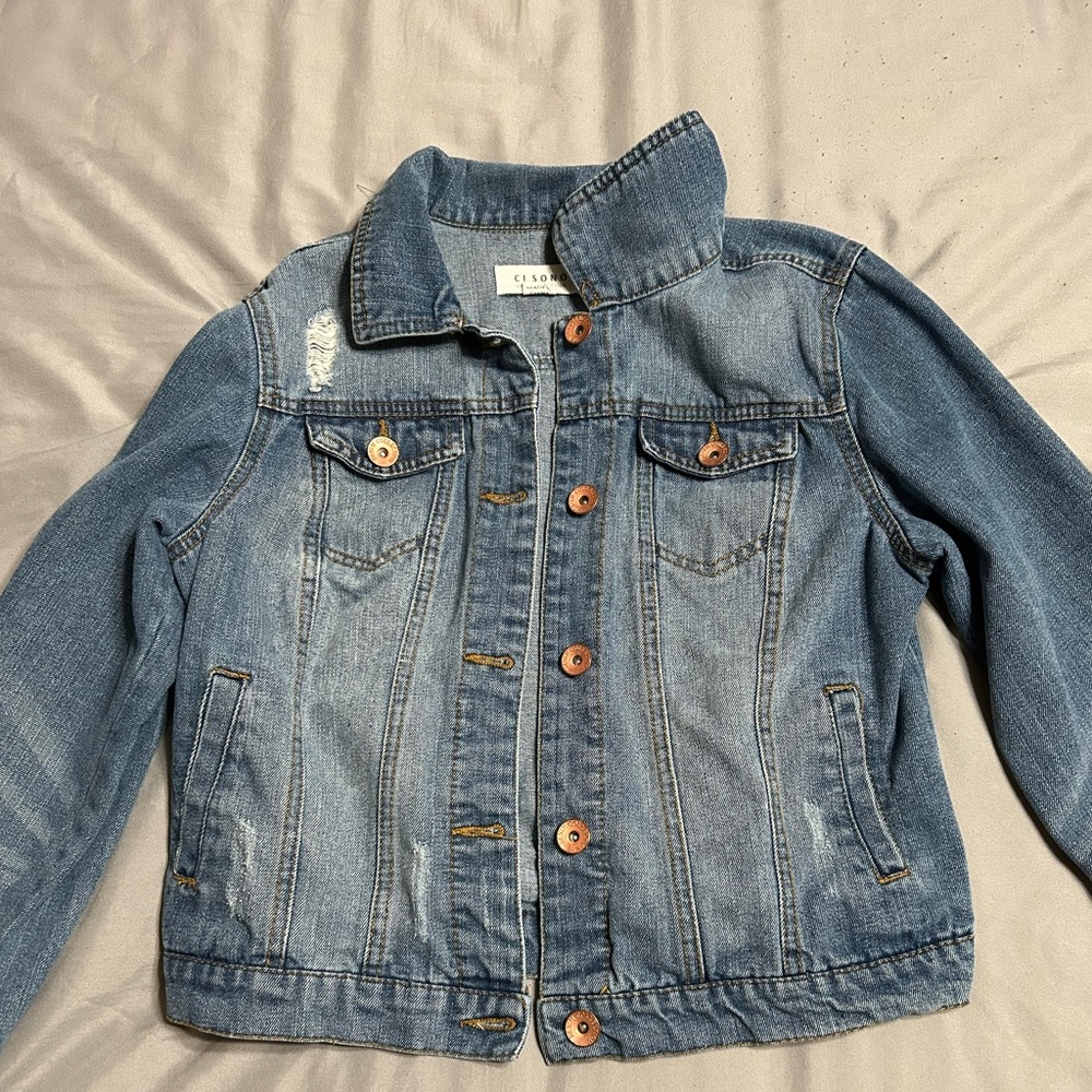 Women’s jean jacket. Runs a little small in size. Fits a size small or x-small.